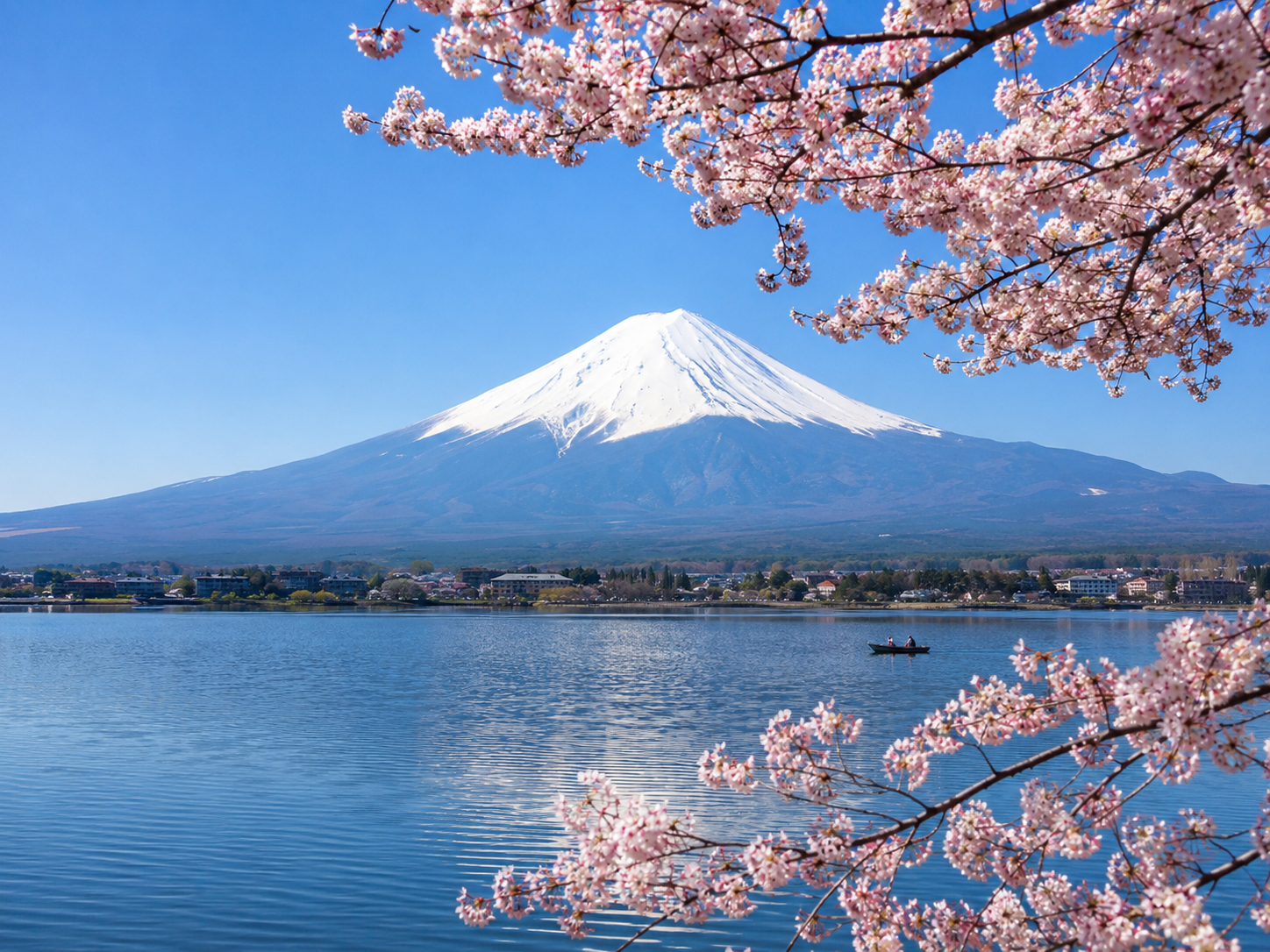 Mount Fuji with cherry blossoms and lake reflection