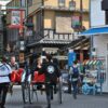Vibrant street scene with traditional rickshaws and bustling shops in a lively marketplace.