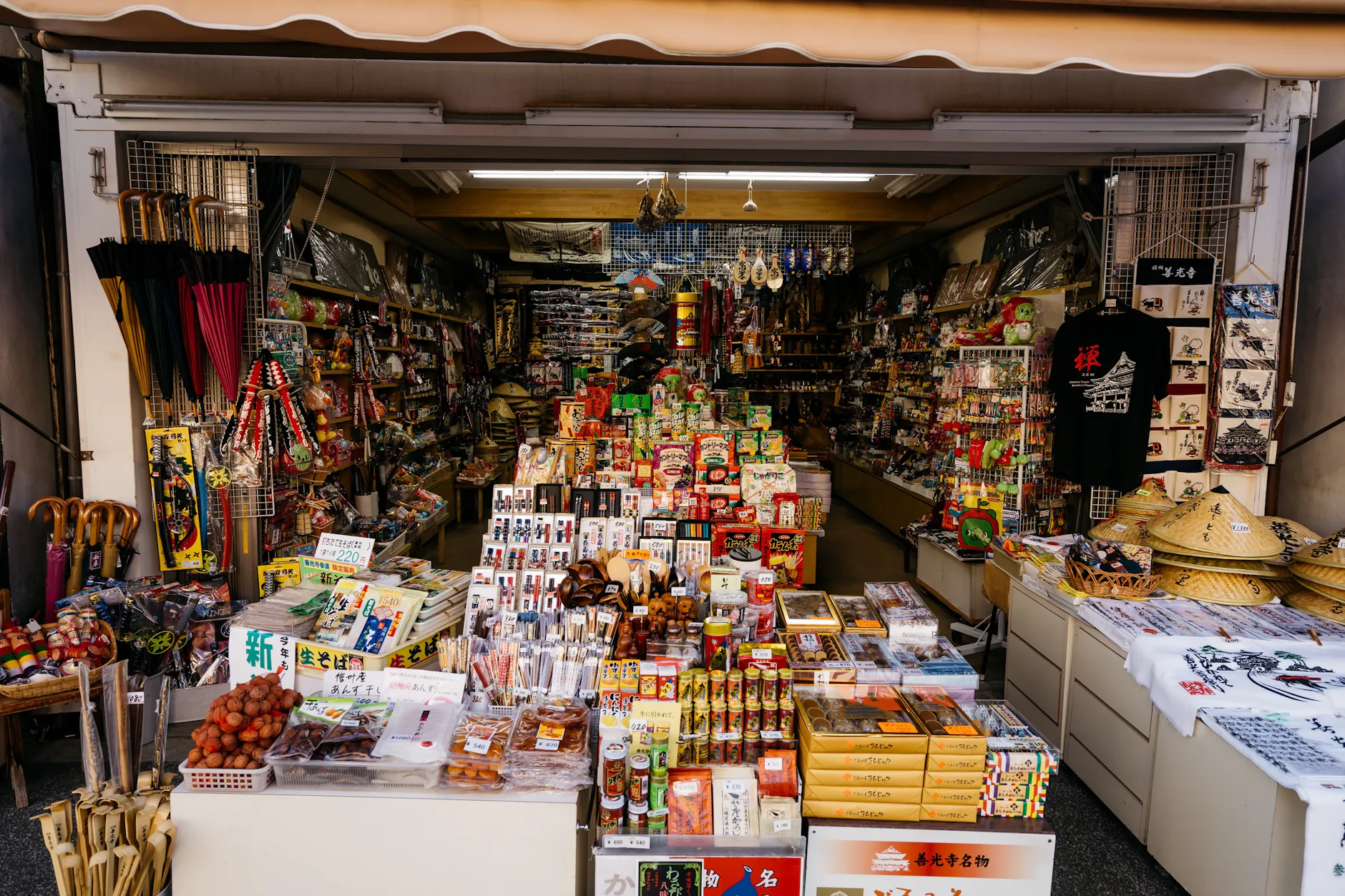 Vibrant market stall with diverse products in Nagano, Japan, showcasing traditional Japanese items.