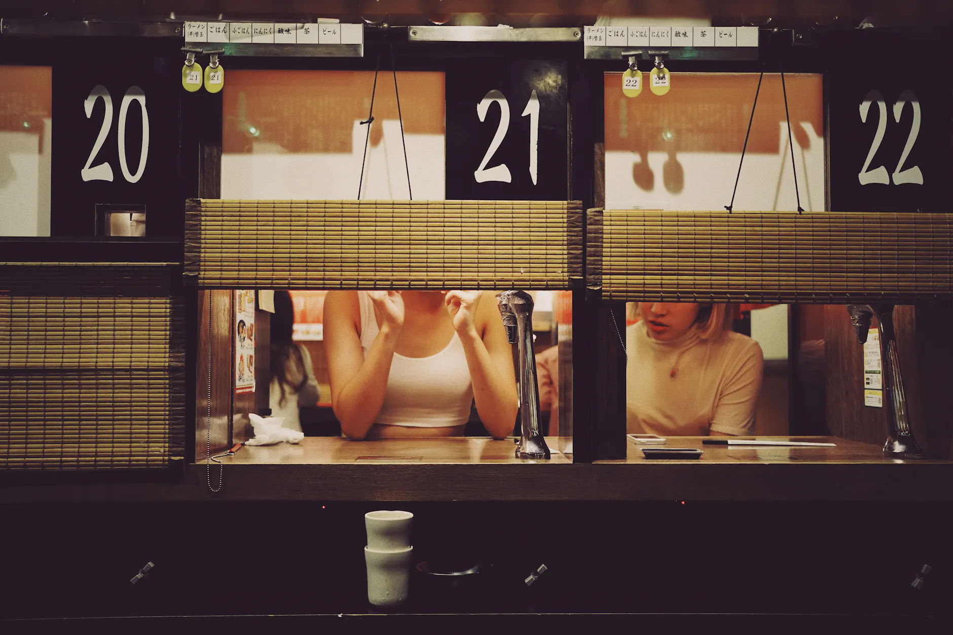 Intimate dining experience at a ramen restaurant in Shibuya, Tokyo with individual booths.