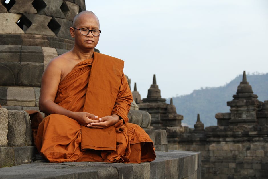 Buddhist monk meditating in traditional robes at an ancient temple