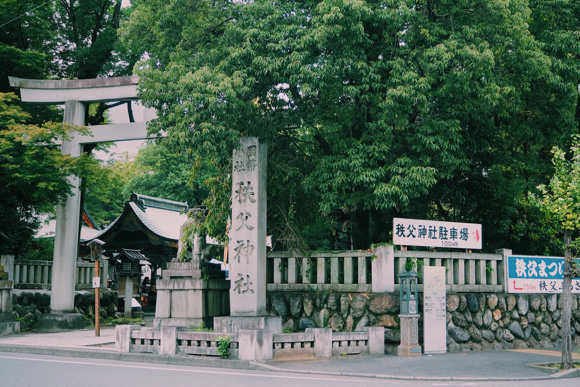 Scenic view of a traditional Japanese shrine entrance in Chichibu with lush greenery.