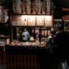 Explore the vibrant street food scene at a traditional Kyoto night market with paper lanterns and bustling stalls.