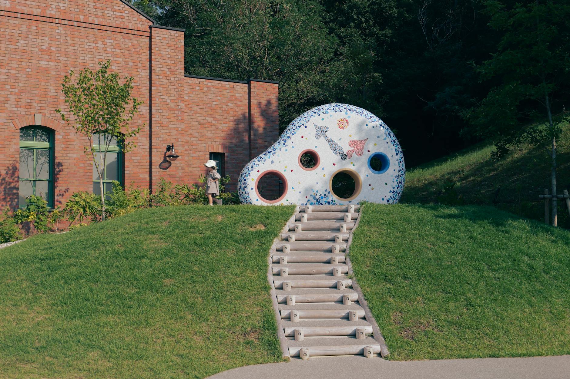 A park in Nagoya, Japan with playful sculpture and grassy landscape.