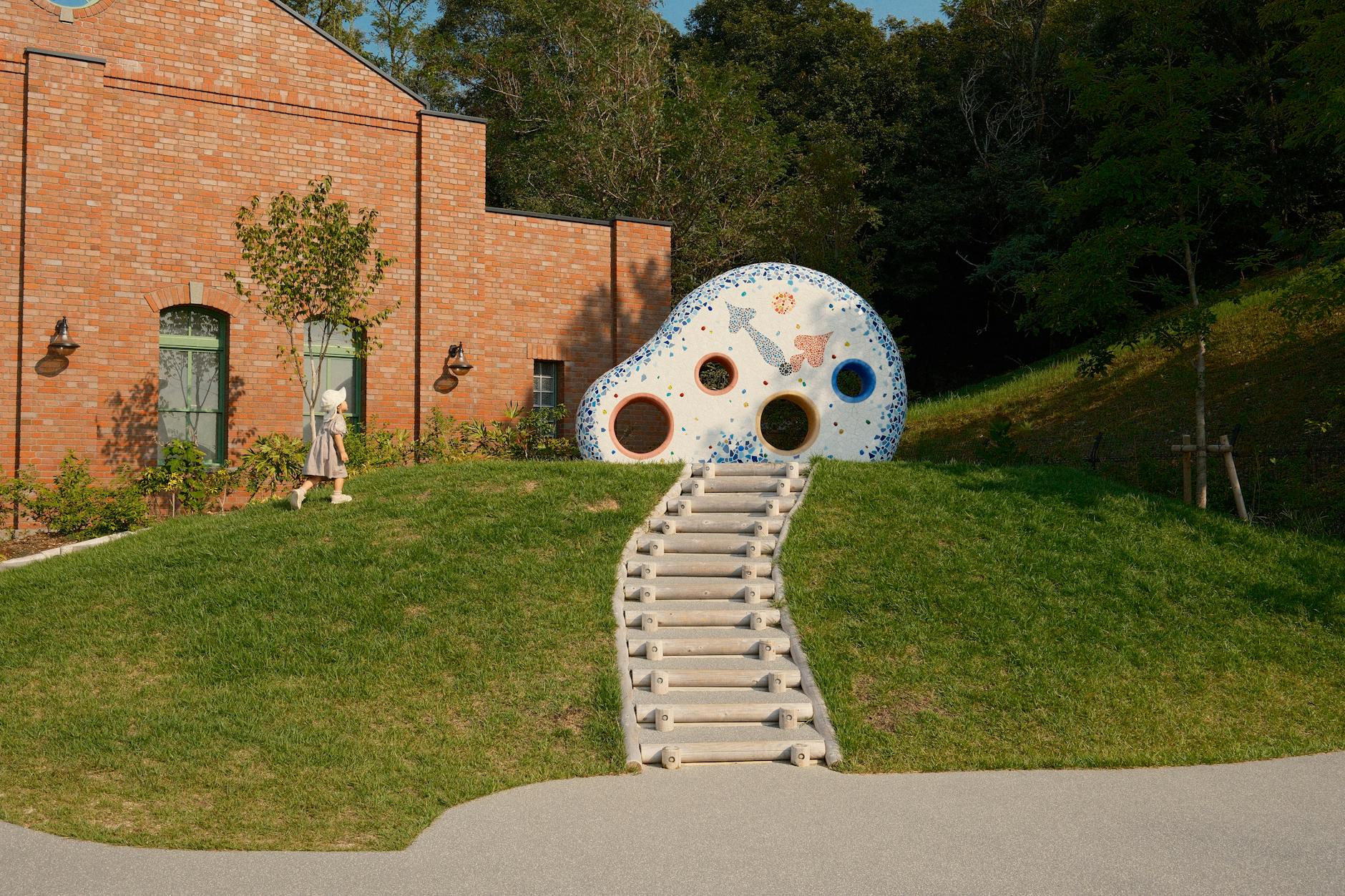 Charming whimsical structure in Ghibli Park, reflecting artistic architecture amidst lush greenery.