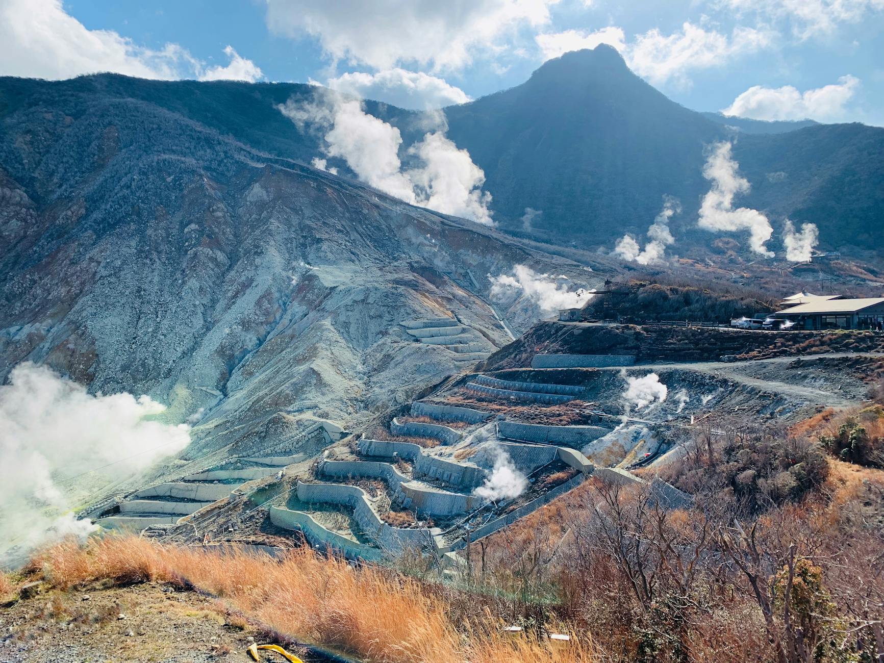 Smoking volcanic valley with fumaroles near majestic rough mountains in Hakone Japan