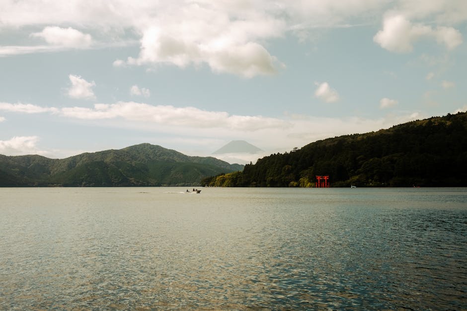 Beautiful view of Lake Ashi with Mount Fuji and red torii gate in Hakone, Japan.