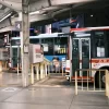 A bustling bus station in Okazaki, Aichi, Japan at night, showcasing lined buses.