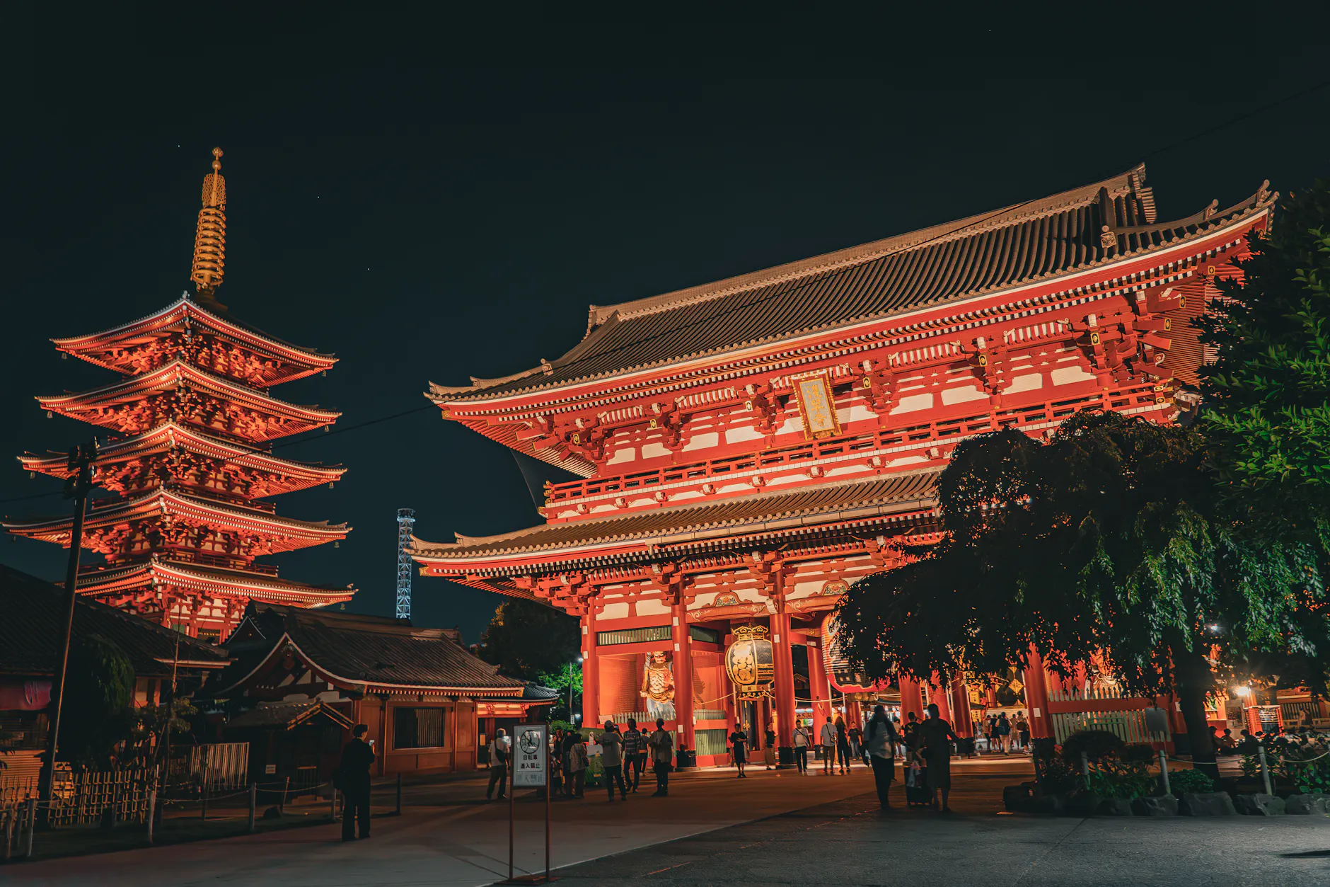 Illuminated Senso-ji Temple in Tokyo at night, showcasing traditional Japanese architecture.