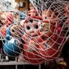 Vibrant collection of vintage dolls in a net display at a museum, capturing a nostalgic Japanese art style.