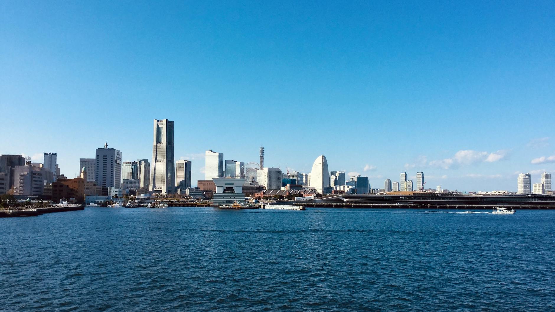 Explore Yokohama's stunning skyline featuring Landmark Tower under a clear blue sky.