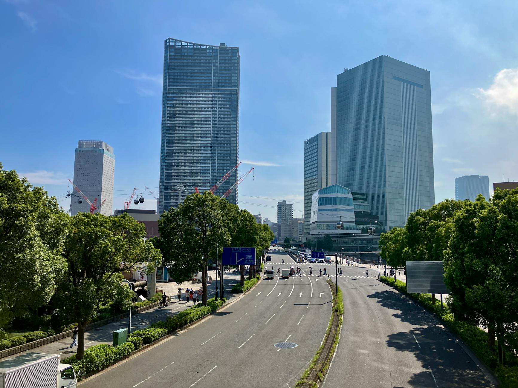 A sunny view of skyscrapers and streets in Yokohama, Japan, showcasing urban architecture.