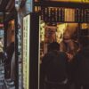 Night scene of a bustling Japanese street food stall in Shinjuku City, Tokyo.