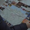 A person examining a detailed map outside during winter, focusing on directions.