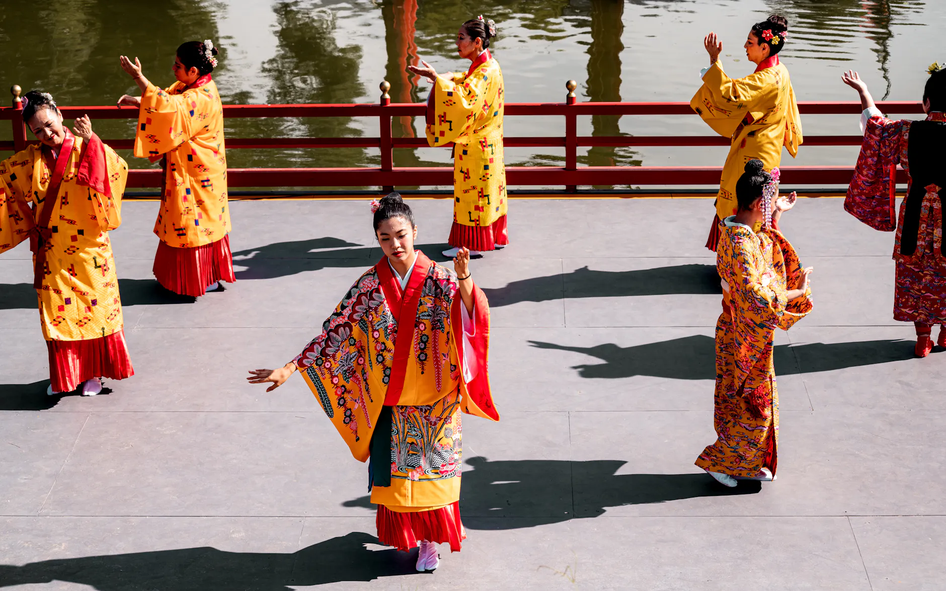 Dancers in traditional Japanese attire performing in a Buenos Aires Japanese garden.
