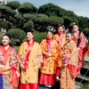 Group of women in vibrant kimonos celebrating Japanese culture in Buenos Aires garden.