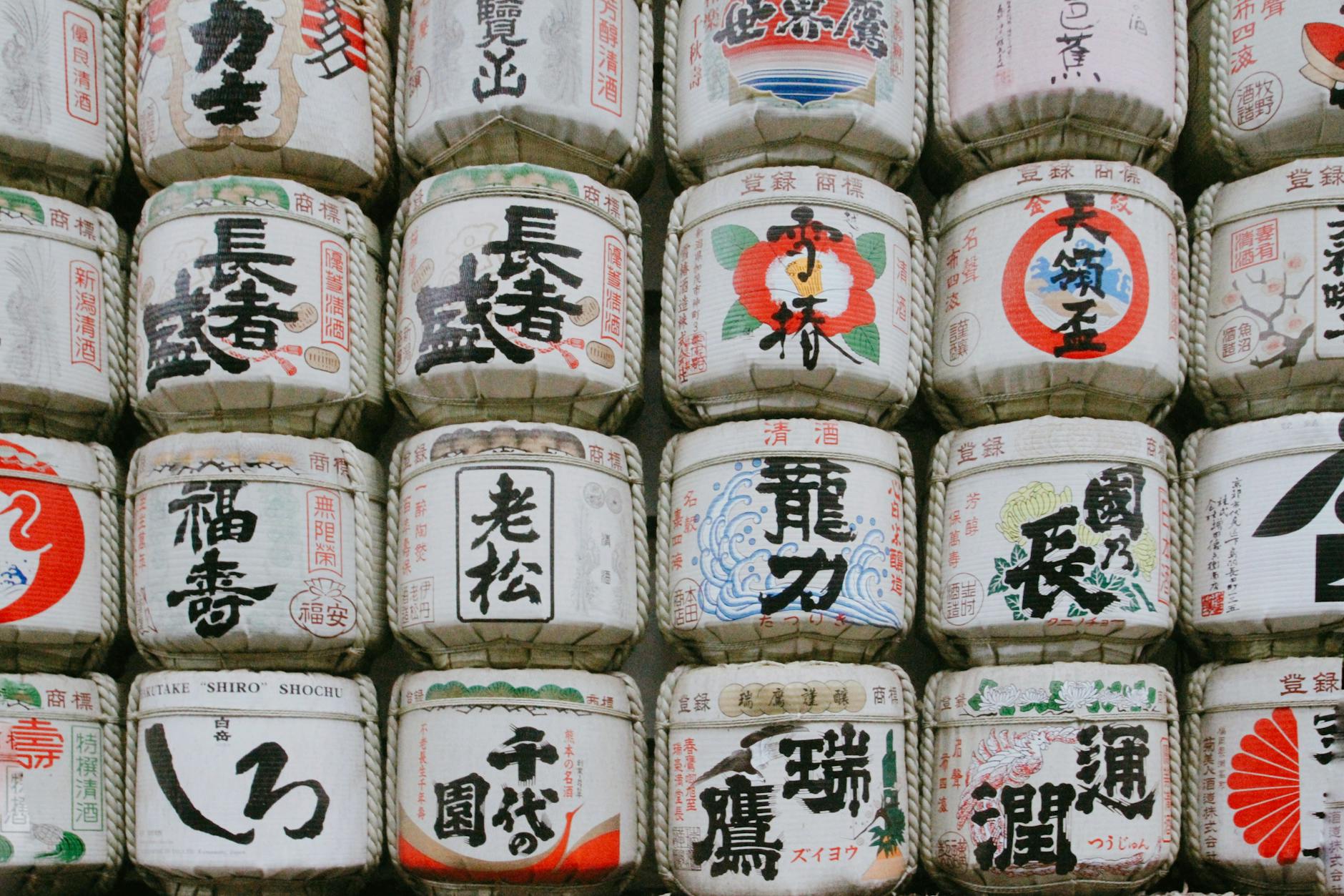 Traditional Japanese sake barrels stacked display at brewery