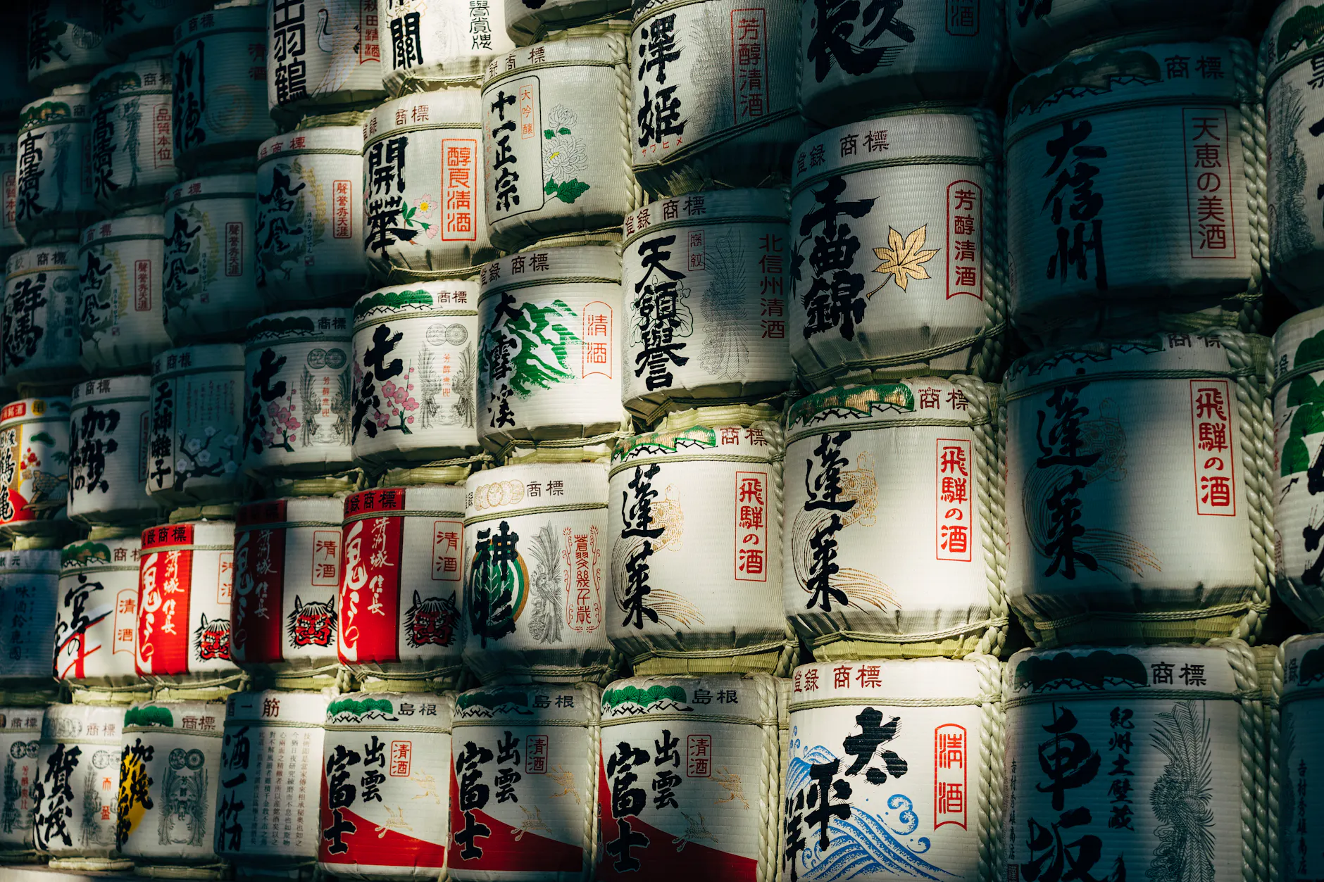 A wall of traditional sake barrels in Shibuya City, Tokyo, showcasing Japanese culture.