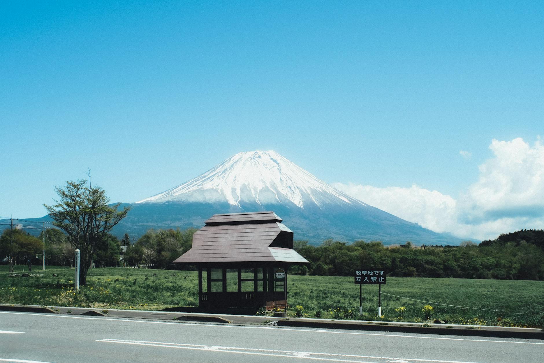 A stunning view of Mount Fuji with a traditional bus stop in Fujinomiya, Japan.