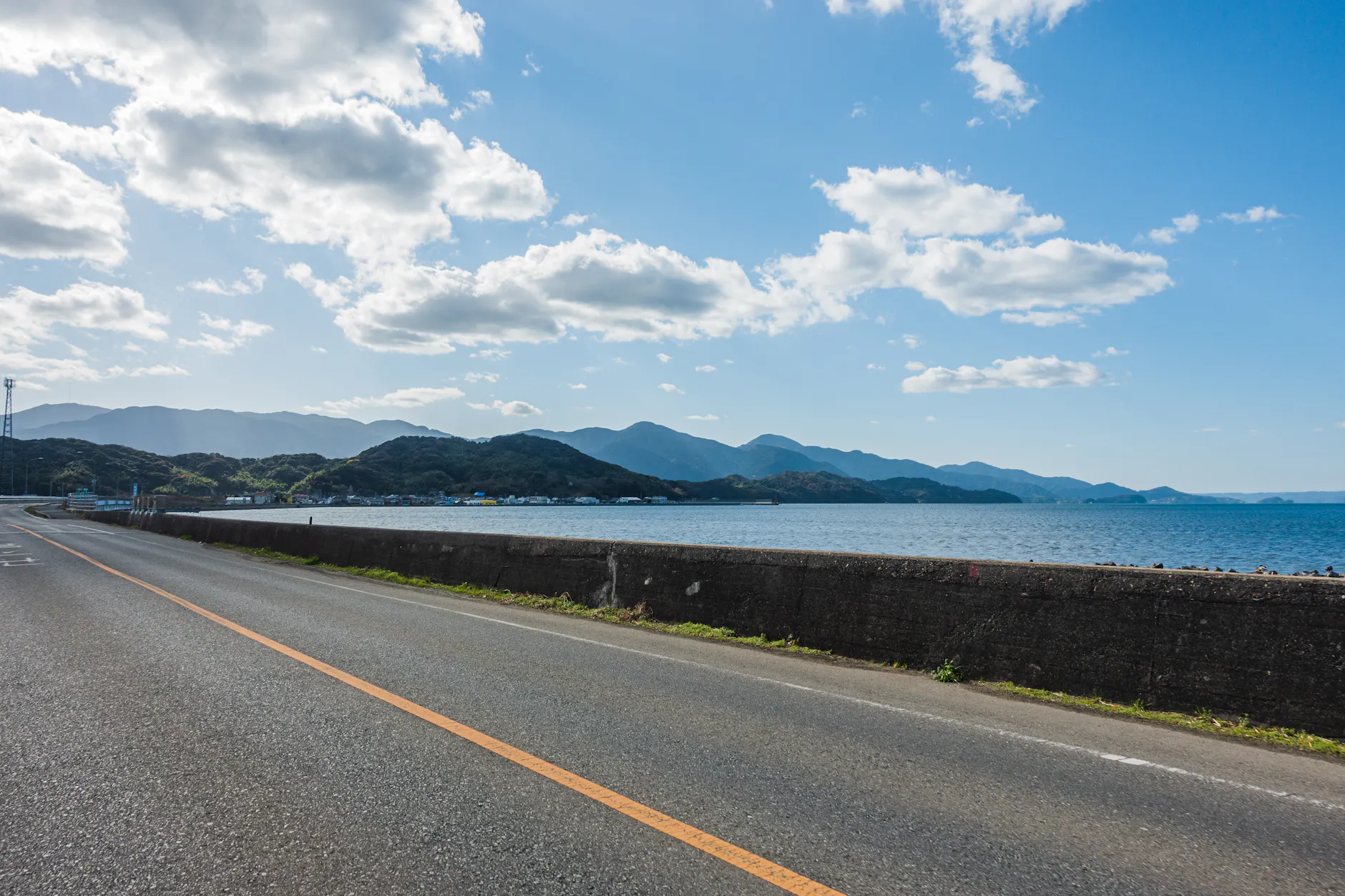 Beautiful view of a coastal road with mountains and sea in Itoshima, Japan.