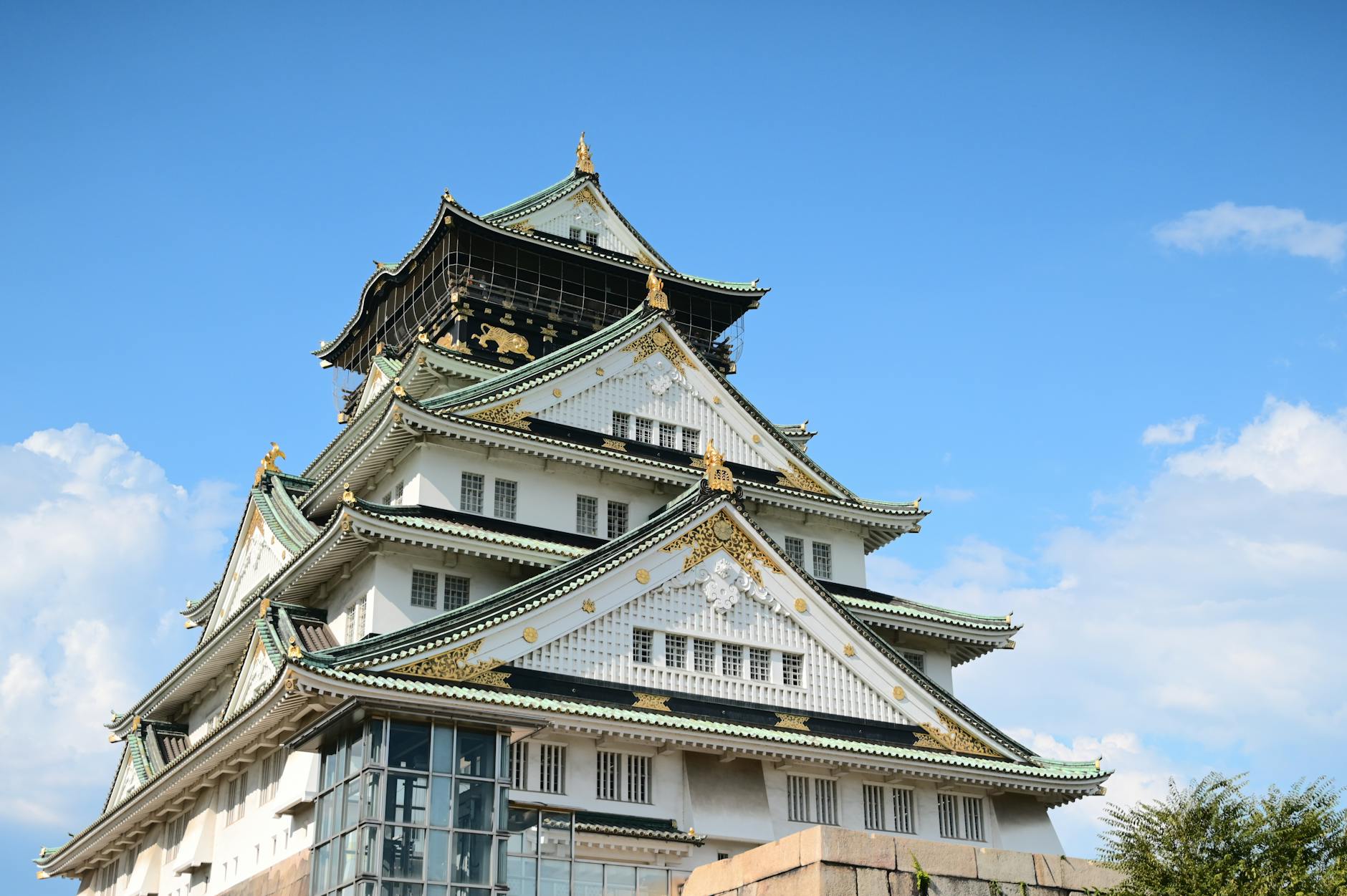 Stunning view of Osaka Castle in Japan against a clear blue sky, highlighting its historical architecture.