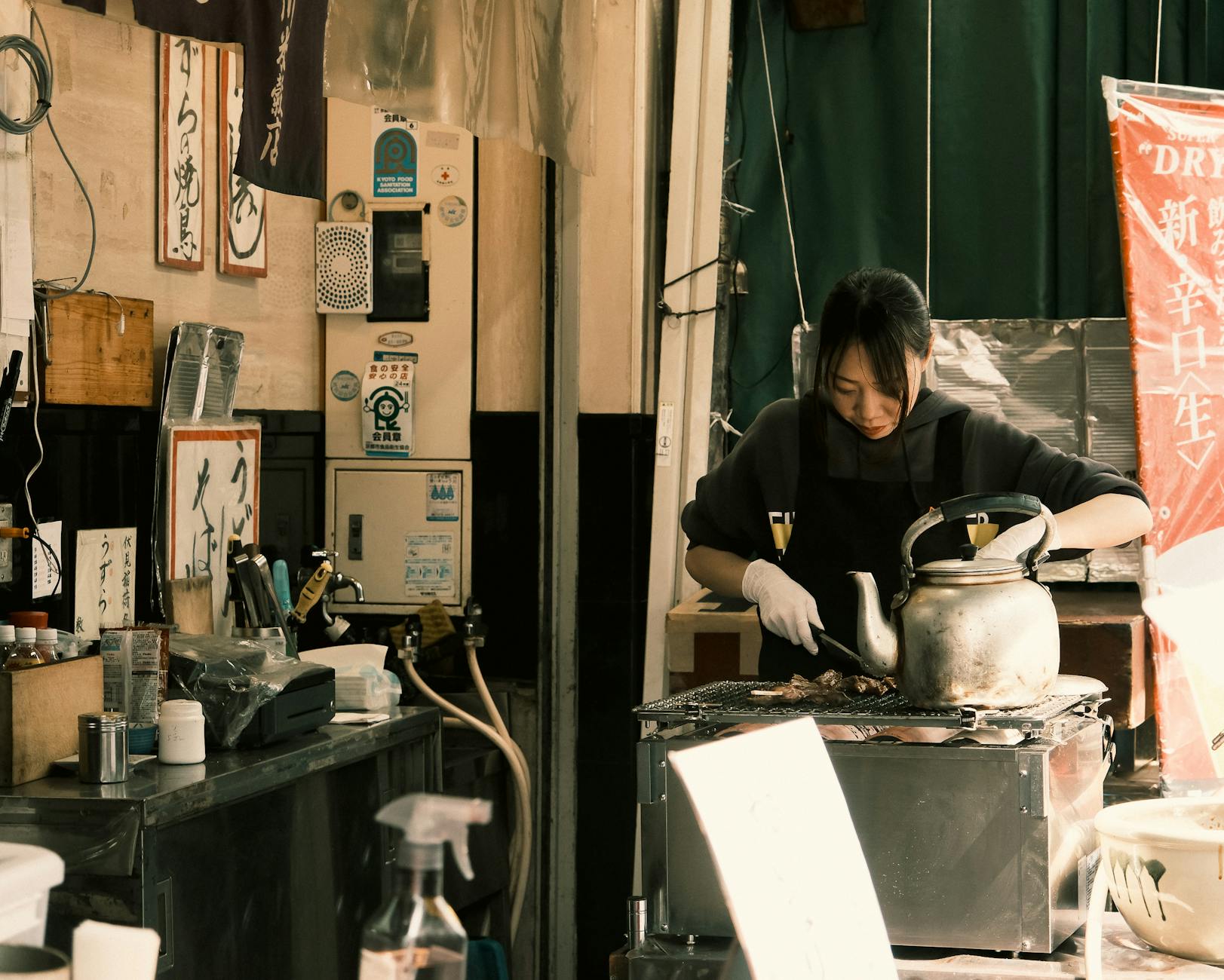 Japanese street vendor preparing food at a stall in Tokyo's bustling market.
