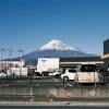 Stunning view of snow-capped Mount Fuji visible from a parking lot in Shizuoka, Japan.