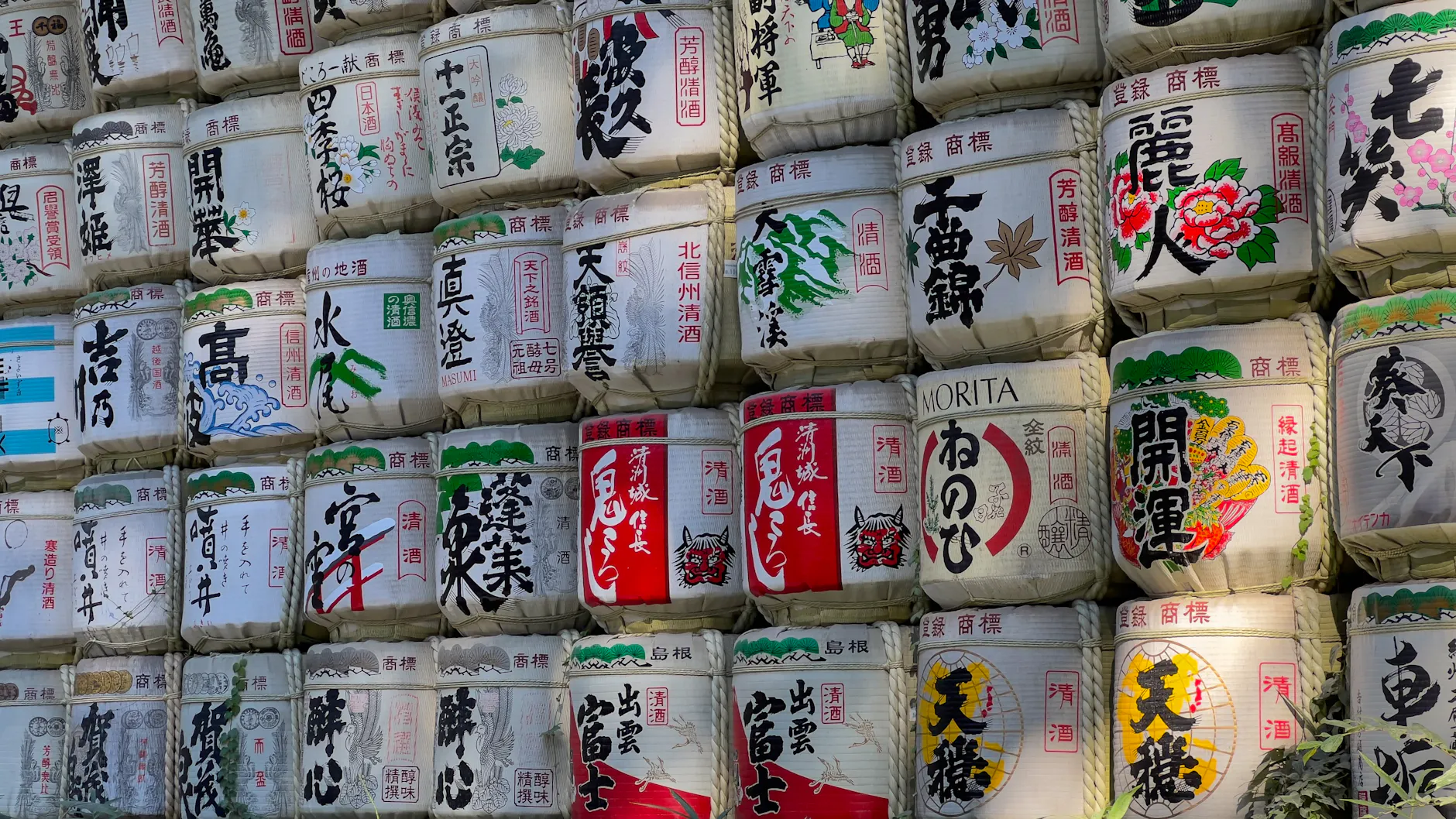 Decorative sake barrels displayed at a shrine in Tokyo, showcasing Japanese culture.