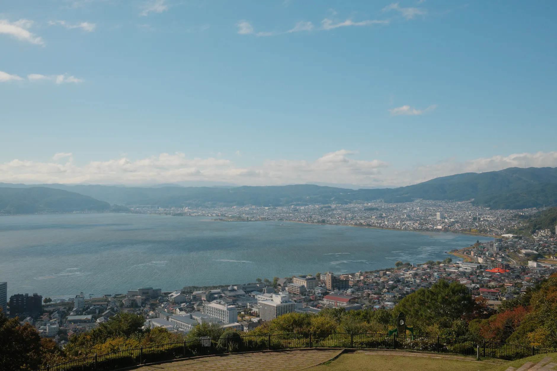 Breathtaking aerial view of Lake Suwa and surrounding cityscape in Nagano, Japan on a clear day.
