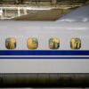 View of the interior of a Shinkansen bullet train through windows at Tokyo Station, Japan.