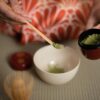 Woman preparing matcha in a traditional Japanese tea ceremony
