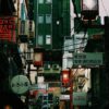 A bustling Tokyo street with neon signs and traditional architecture captures the vibrant nightlife in Japan's capital.