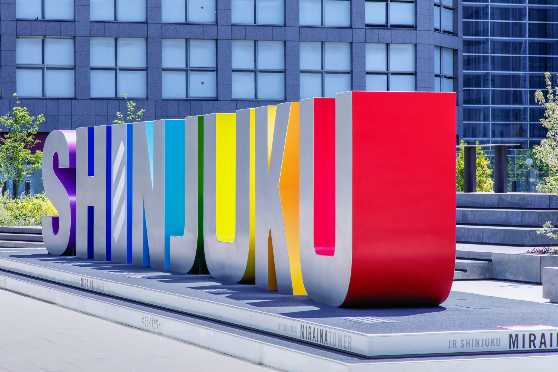 Vibrant Shinjuku sign in front of modern skyscrapers in Tokyo, Japan.