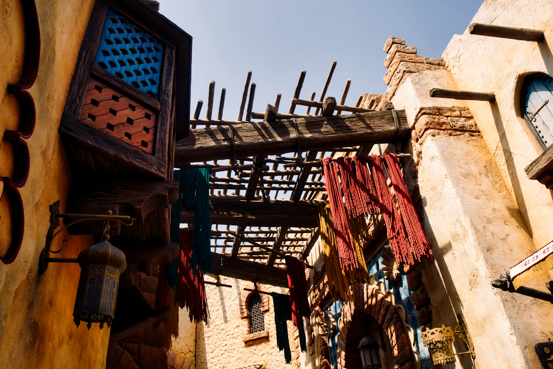 Vibrant architectural scene at Tokyo DisneySea, featuring intricate woodwork under sunlight.