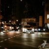 Busy night traffic scene in Shinjuku, Tokyo capturing cars and a vibrant city atmosphere.