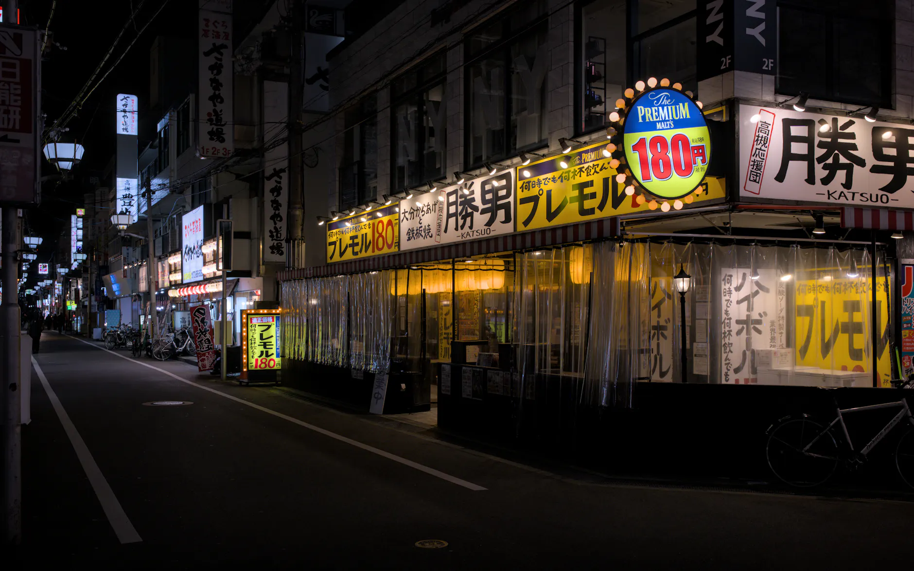 Explore the quiet, illuminated streets of Takatsuki, Osaka with its iconic izakayas at night.