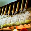 A close-up of noodle strainers hanging in a Japanese ramen restaurant, showcasing culinary tools.