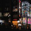 Bright neon signs illuminate the bustling streets of Shinjuku at night, capturing Tokyo's vibrant nightlife.