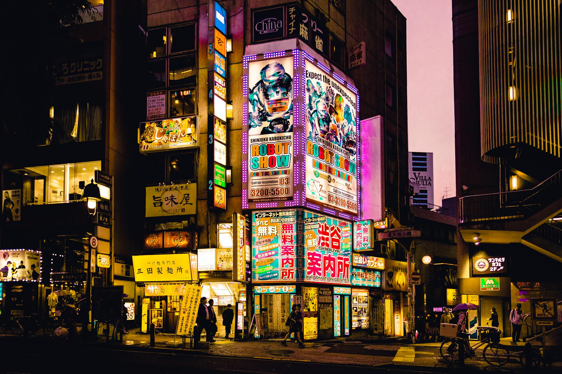 Explore the vibrant nightlife of Shinjuku, Tokyo with colorful neon signs illuminating the bustling streets.