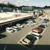 Aerial shot of a supermarket parking lot with parked vehicles in Toyota, Aichi, Japan.