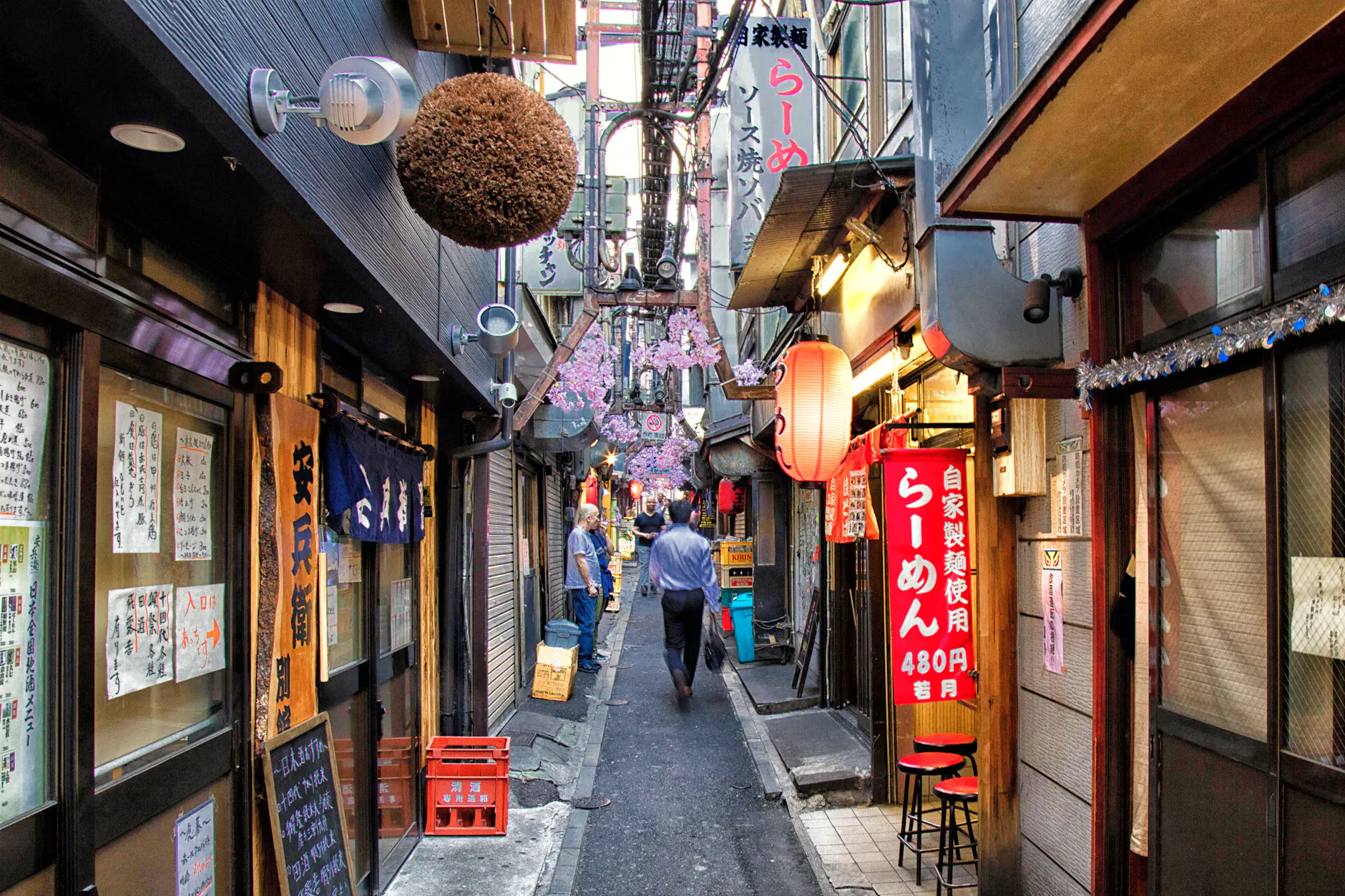Explore a vibrant alleyway in Tokyo, Japan, featuring traditional restaurants and unique atmosphere.