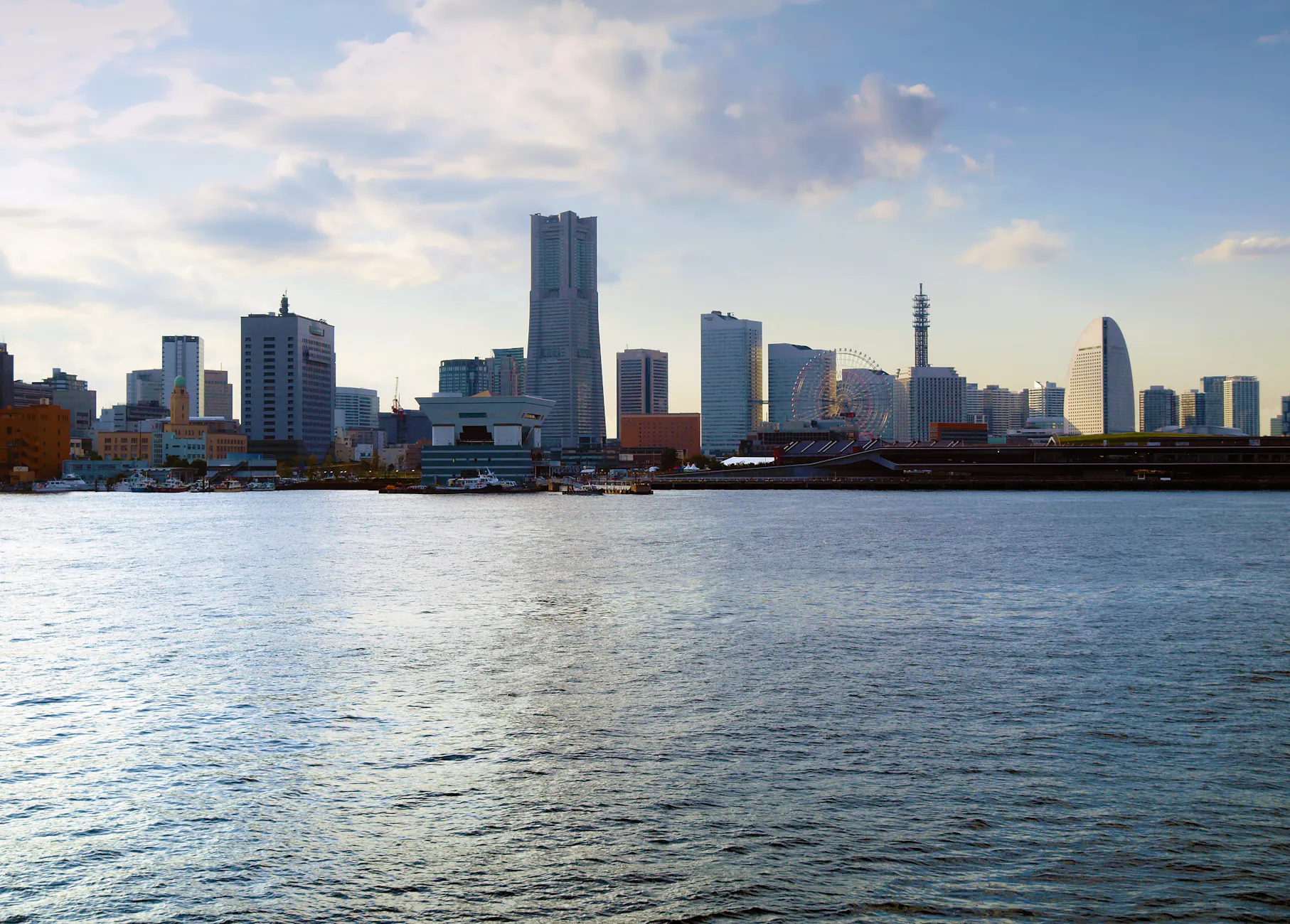 Scenic daytime view of Yokohama's skyline with iconic landmarks across the bay