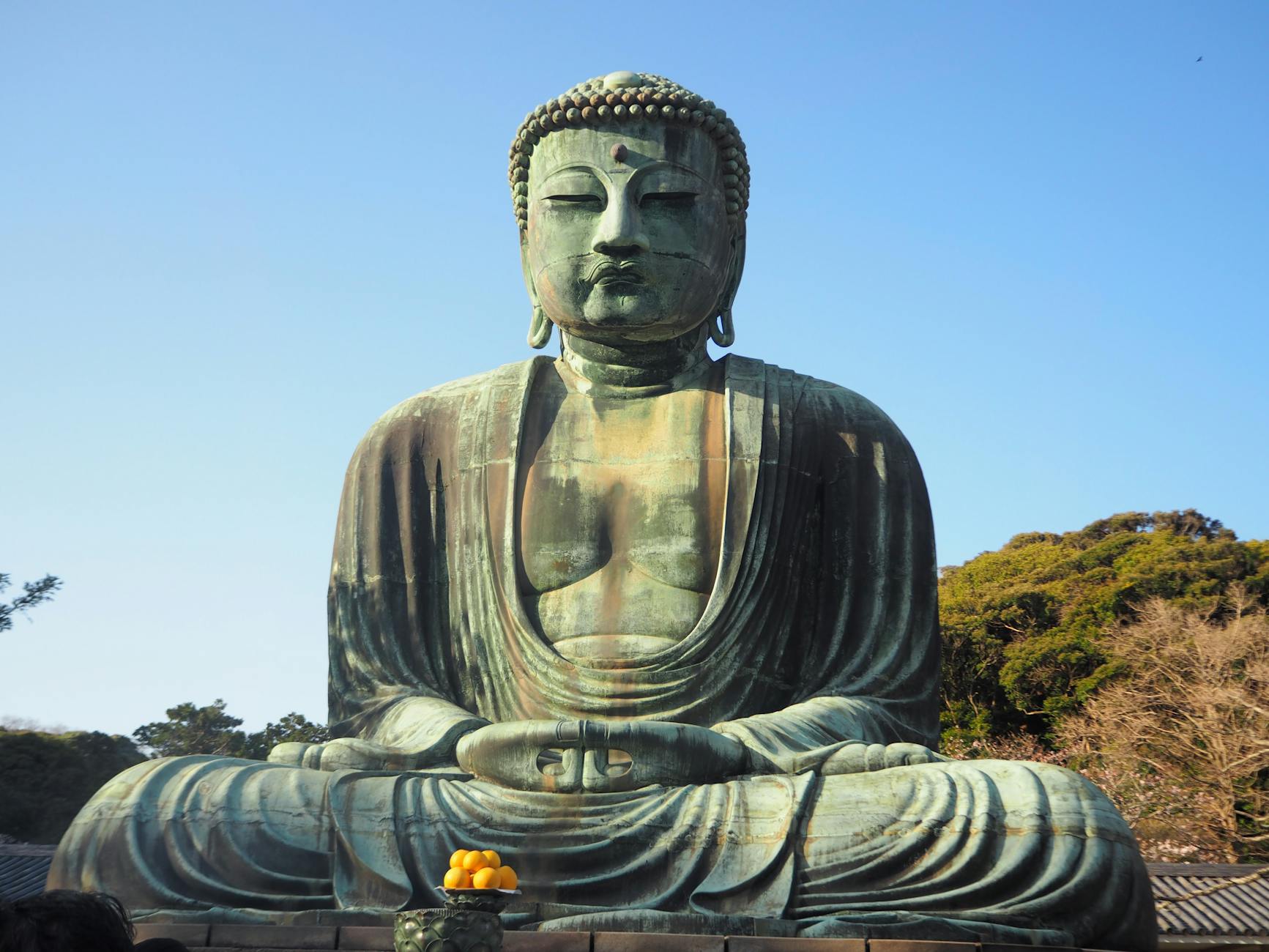 The Great Buddha statue at Kotoku-in Temple, Kamakura, during daylight.