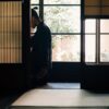 Person practicing zazen meditation in a traditional Japanese room with shoji screens